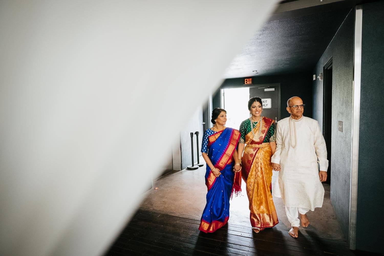 The bride and parents make their way down the aisle Brazos Hall Austin South Hindu asian wedding ceremony