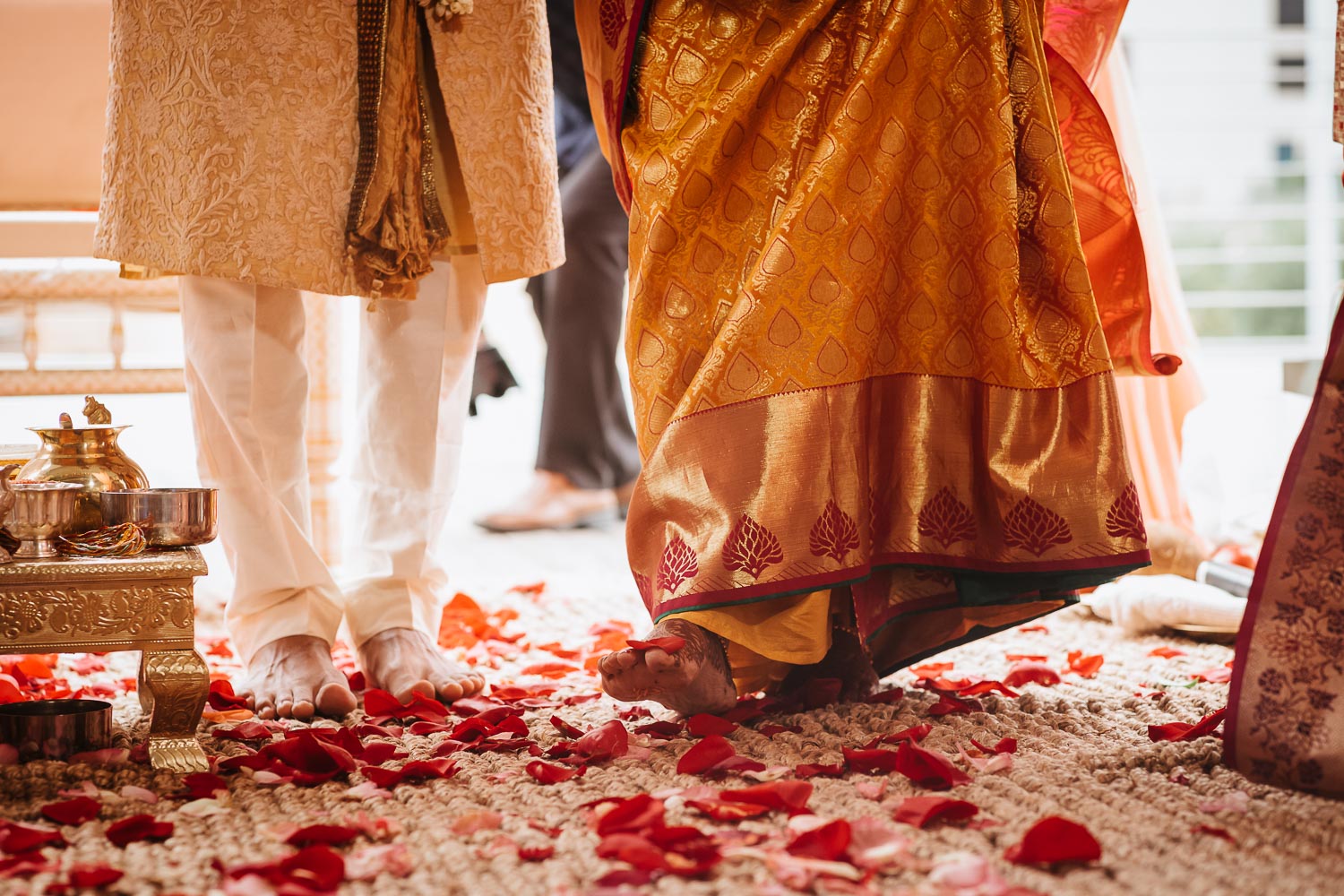 Bride and groom under the mandcap take steps as husband and wife Brazos Hall in Austin Texas