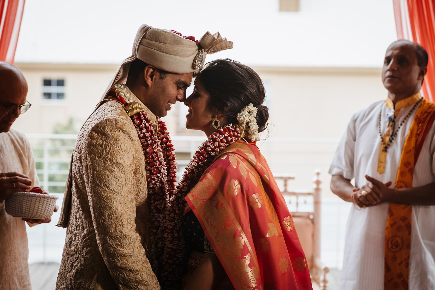 Brazos Hall in Austin Texas south asian ceremony show the couple close up facing each other under mancap