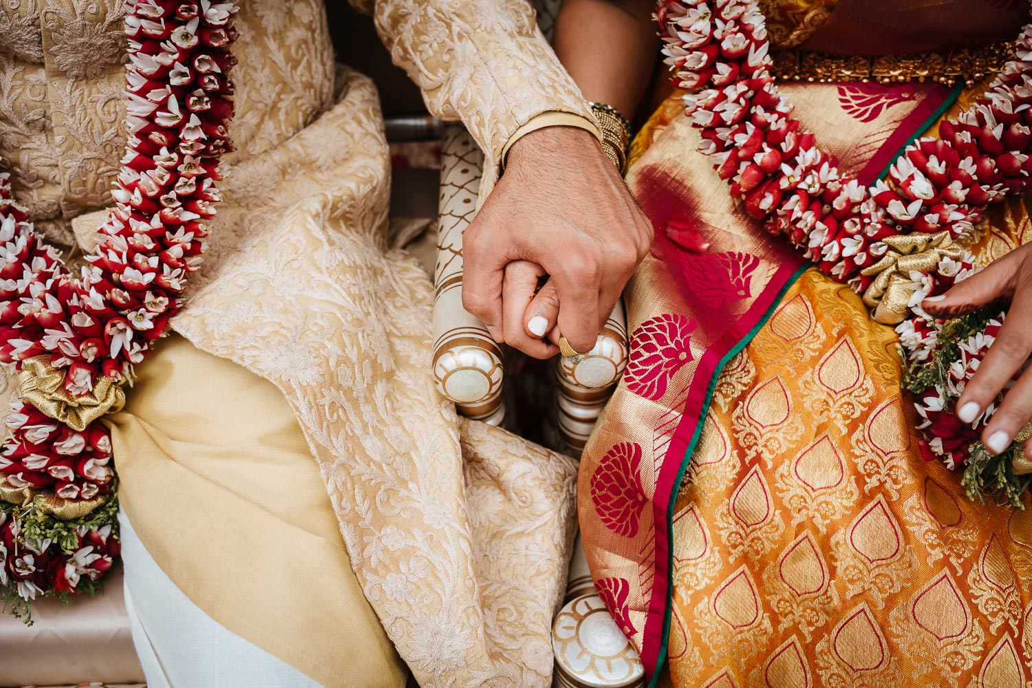 During a south asian wedding ceremony couple hold hands