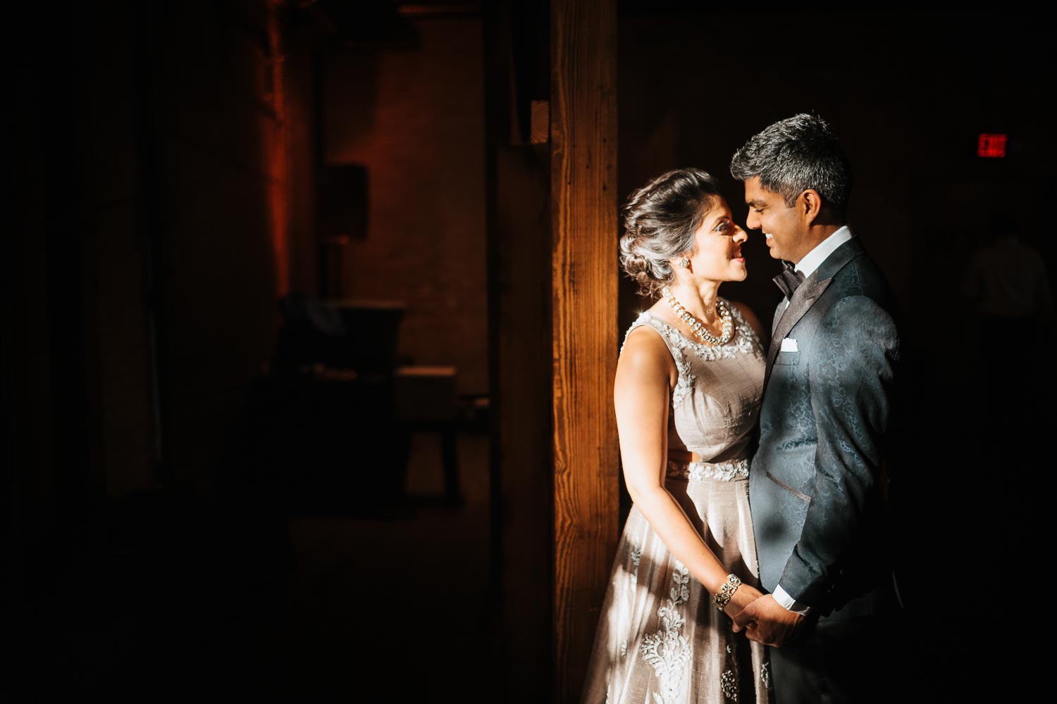 Couple pose in beautiful sunlight inside the hall at Brazos-Hall-South-Asian-Indian-wedding-_-Neha-Mrugesh-Philip-Thomas-Photography