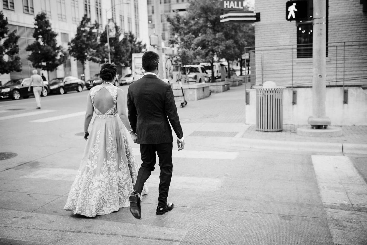 Just married couple return to venue walking across Brazos Street in downtown Austin