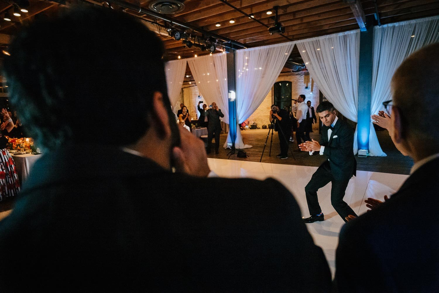 Groom dances upon reception entrance at Brazos Hall