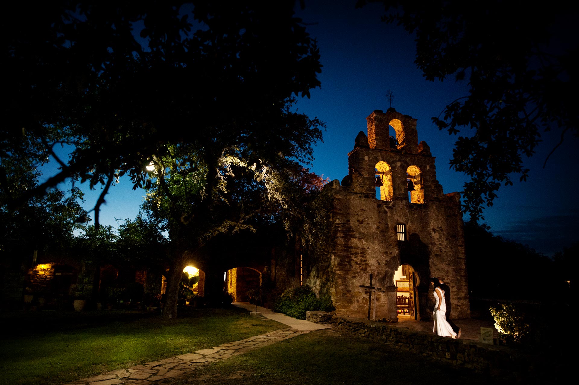 Bride and groom arrive at Mission Espada, San Antonio, Texas for their wedding. Photograph by Philip Thomas Photography.