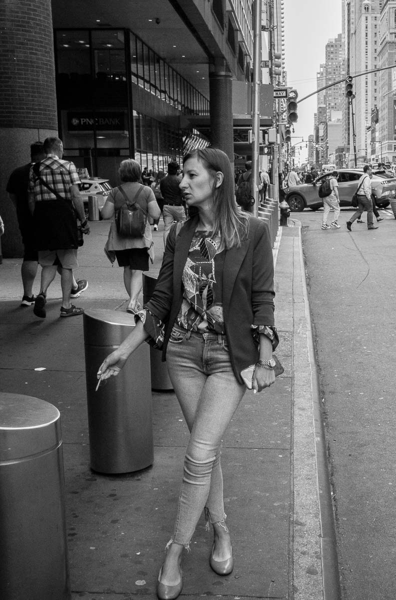 A lady on a smoke break along 8th avenue - street shooting in NYC L1000308