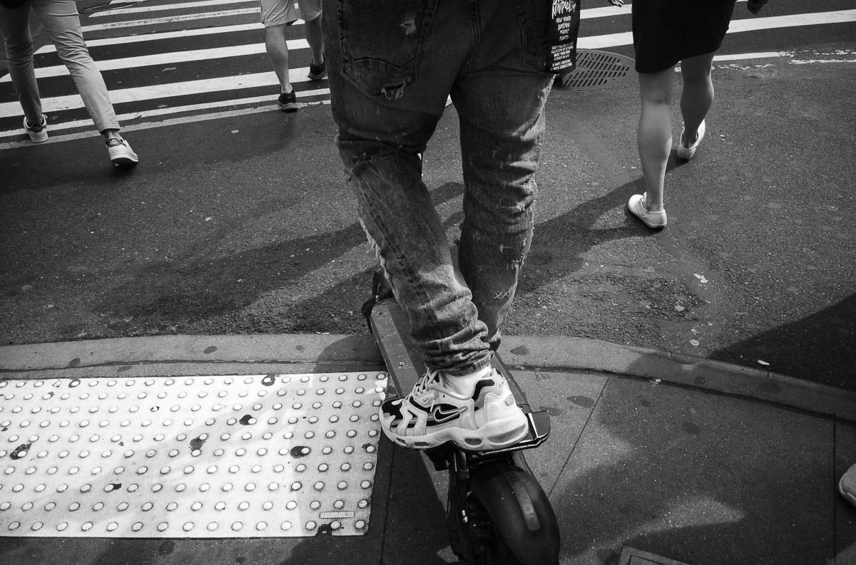 A uber eats delivering on a skateboard in NYC - Street photography in New York by Philip Thomas L1000317