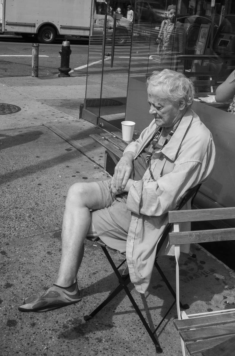 A man sits in the summer sun at Carve - 760 8th Avenue SE L1000331