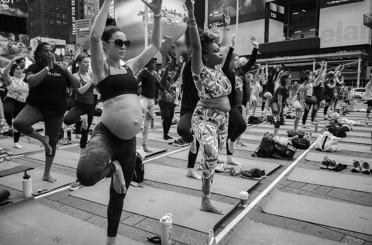 Yoga classes in Times Square with a pregnant lady in foreground - L1000345