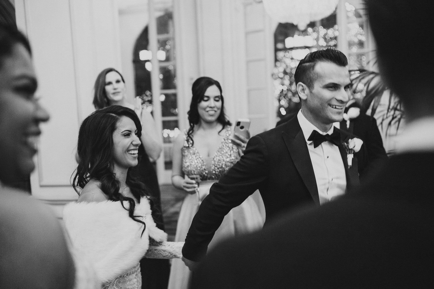 A newly wedded couple hold hands and are greeted by guests at St. Anthony Hotel Wedding - San Antonio TX _ Celina + Lorenzo -49