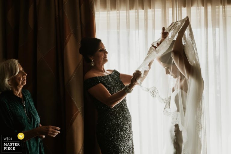 San Antonio wedding photographers Philip Thomas with Mother and grandmother of the bride assist bride with her veil at The Westin Riverwalk Hotel in San Antonio Texas - WPJA Award winning image San Antonio wedding photographer Philip Thomas