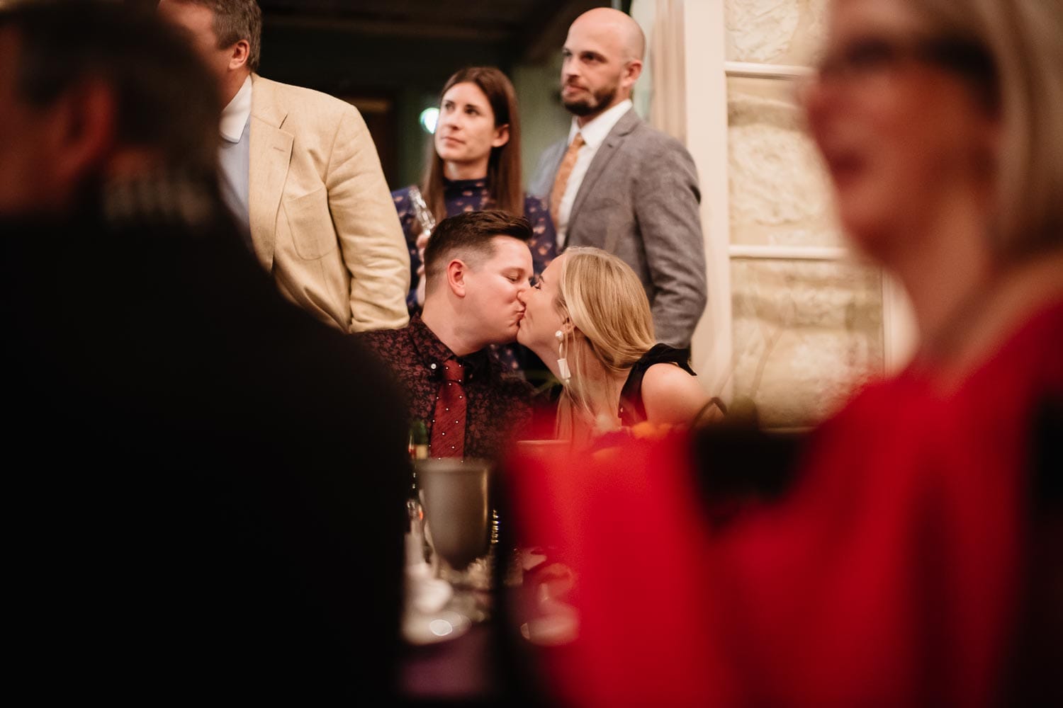 The couple steal a quick kiss duitng the welcome wedding dinner at Club Giraud