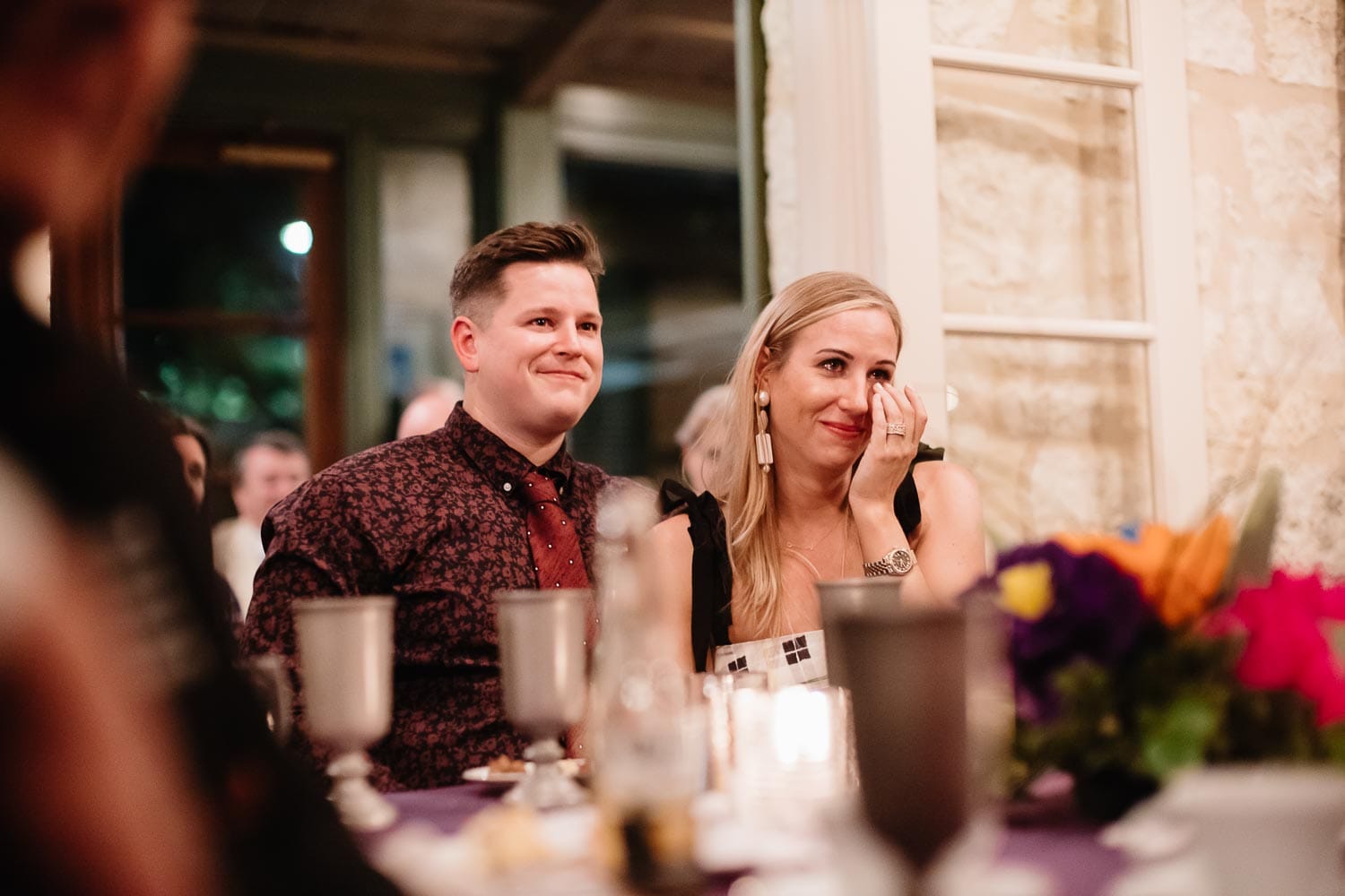 Kelsey wipes away a tear during the toasting at a welcome dinner