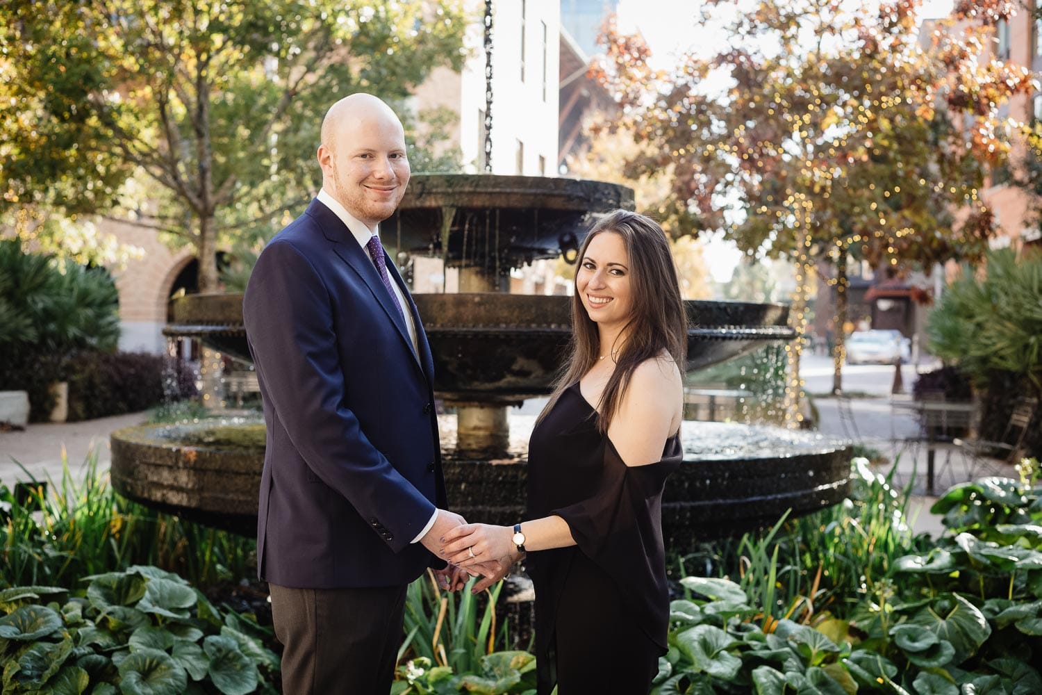 Debra and Ryan pose in front of water fountain at the Pearl