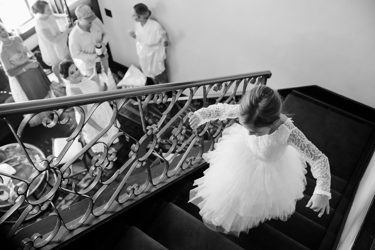 A flower girl walks up stairs in a hotel room at Hotel Havana