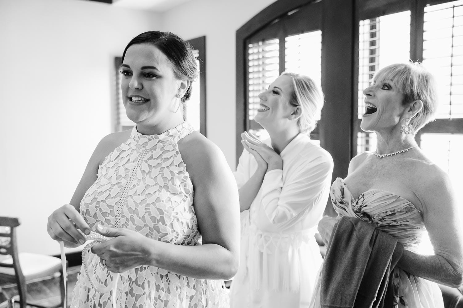 The mother of the bride sister and mother react to flower girls dressed