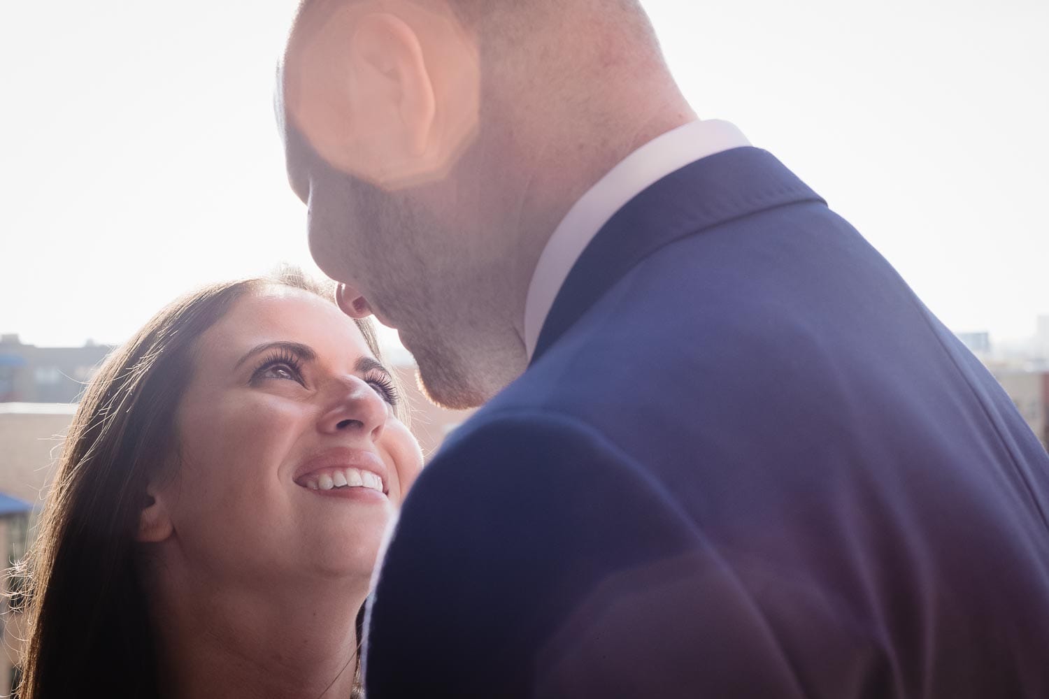 Bride to be looks up into eyes of husband to be engagement shoot