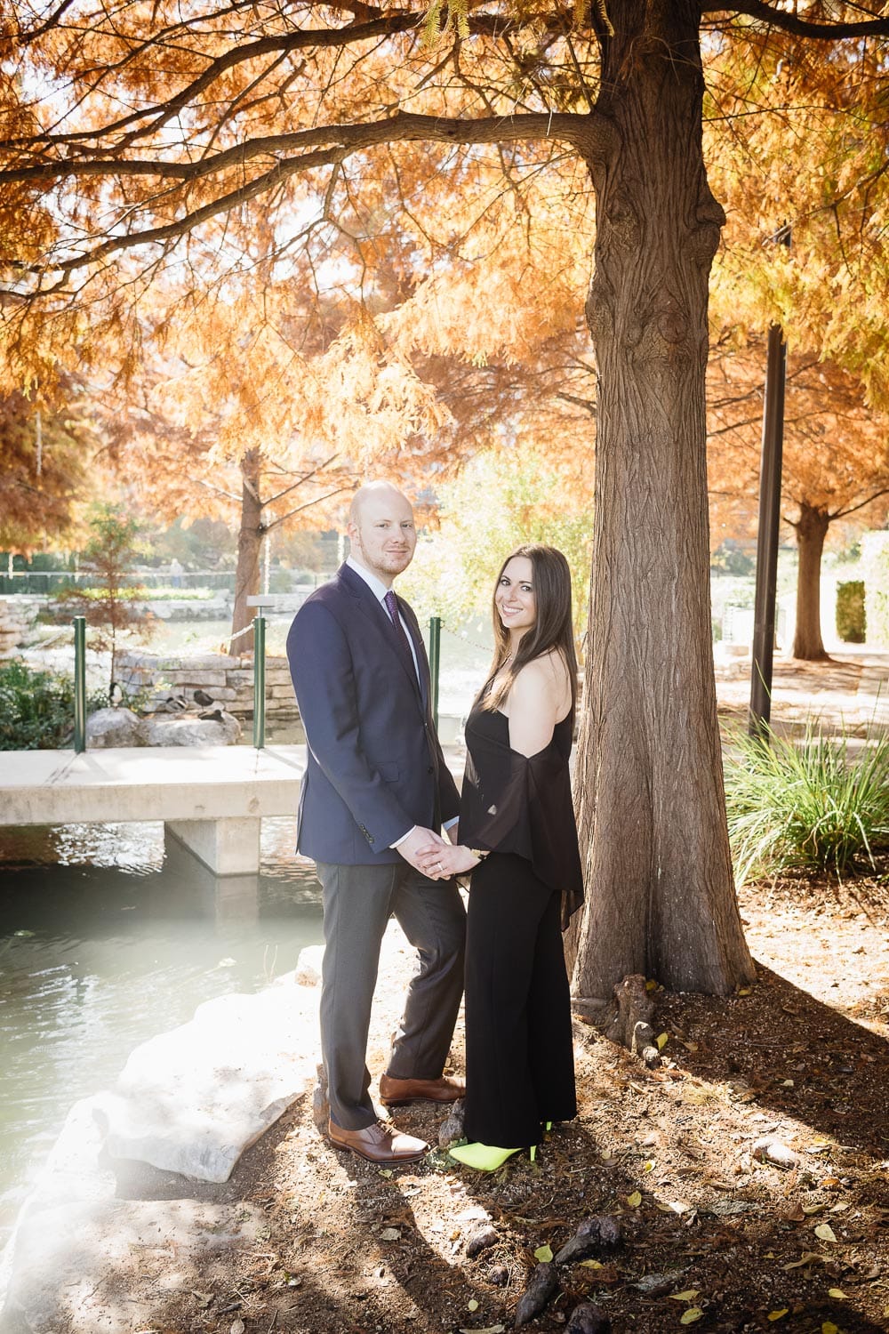 Gorgeous fall colors create background for couples engagement shoot San Antonio river