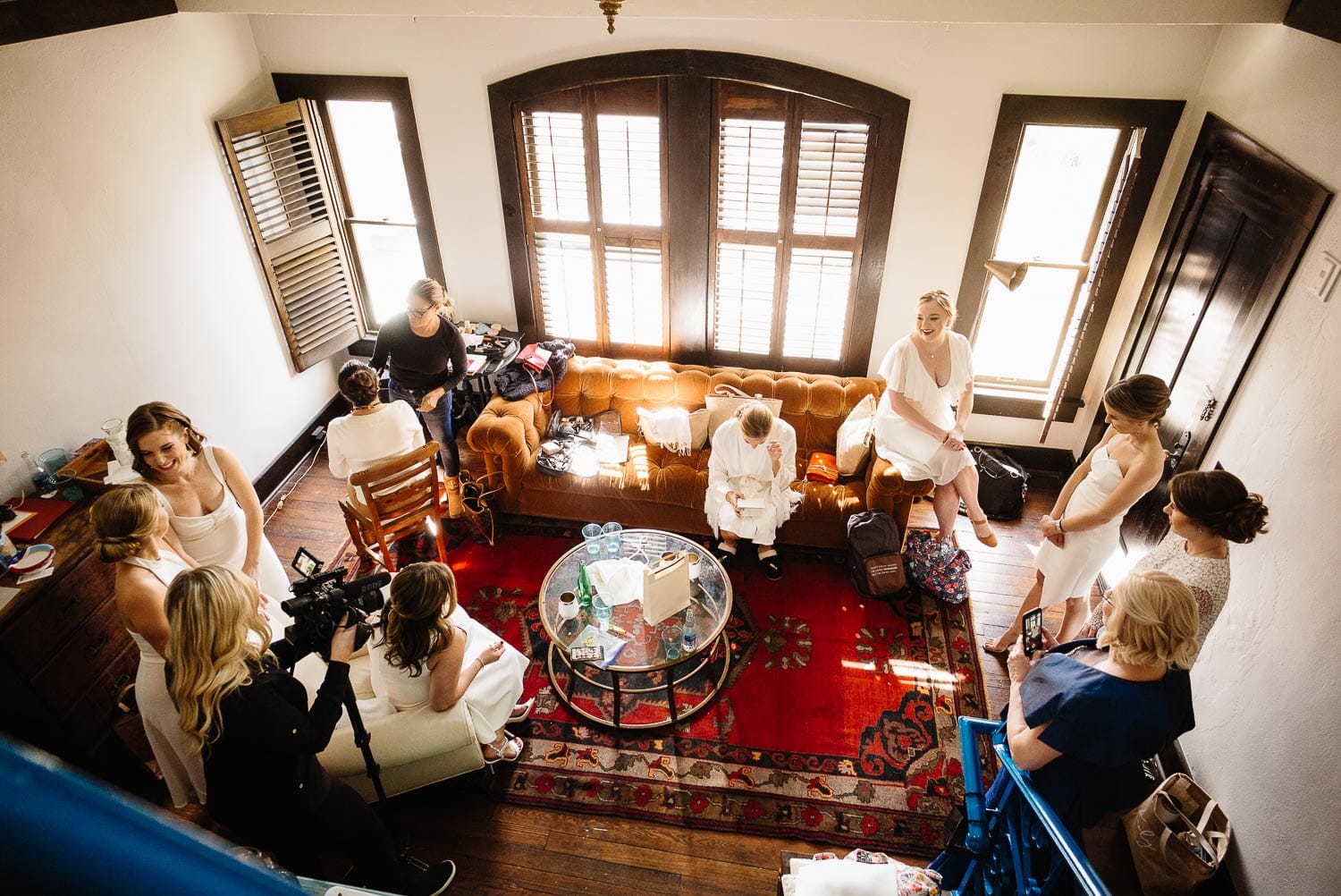 Wide shot looking dow on bride and bridesmaids getting ready