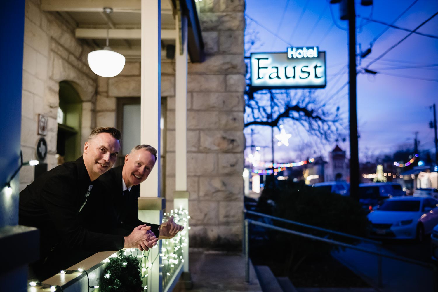 Couple on walk about pose outside Hotel Faust in Comfort Texas LM104447