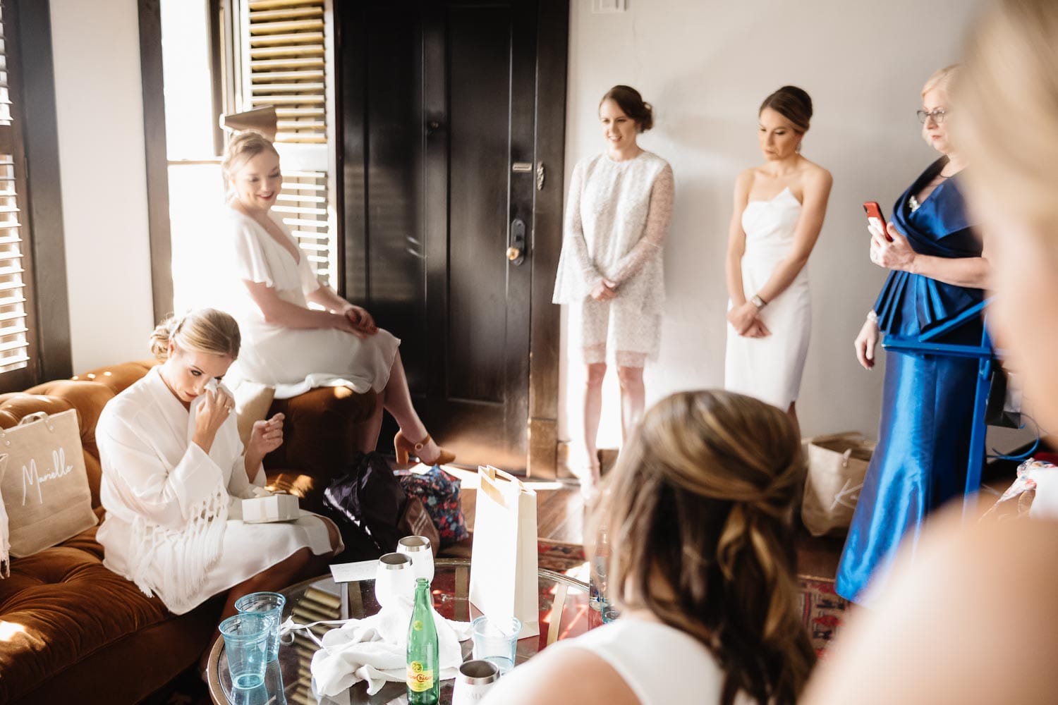 The bride wipes away a tear as she reads a love letter from the groom