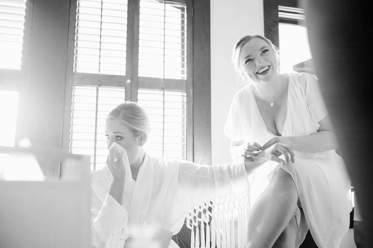 More tears from the bride and a heloing hand as bridesmaids add a bracelet to her wrist