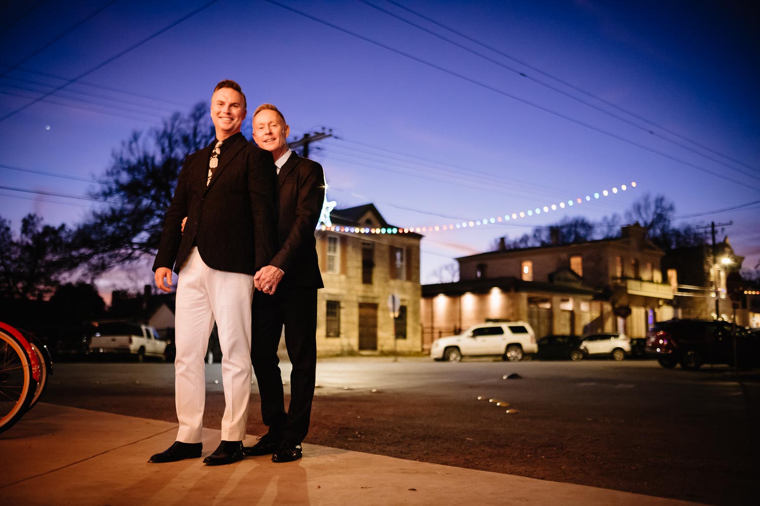 Couple pose across from Ingenhuett on High on their wedding evening LM104508