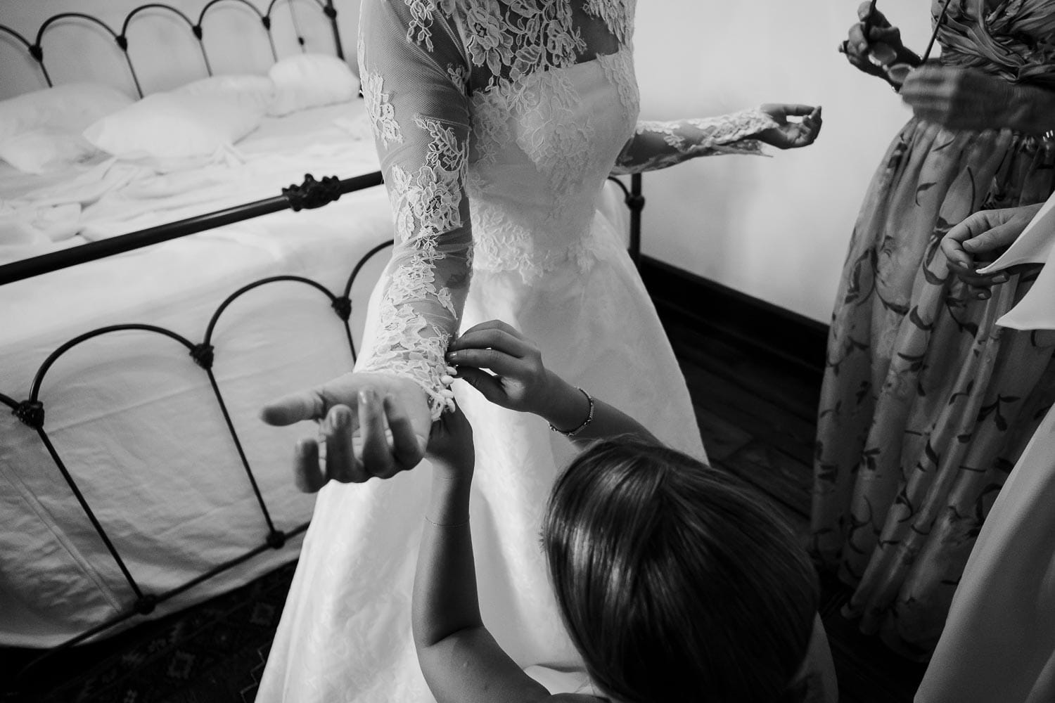 The bride has help from bridesmaid as she gets ready