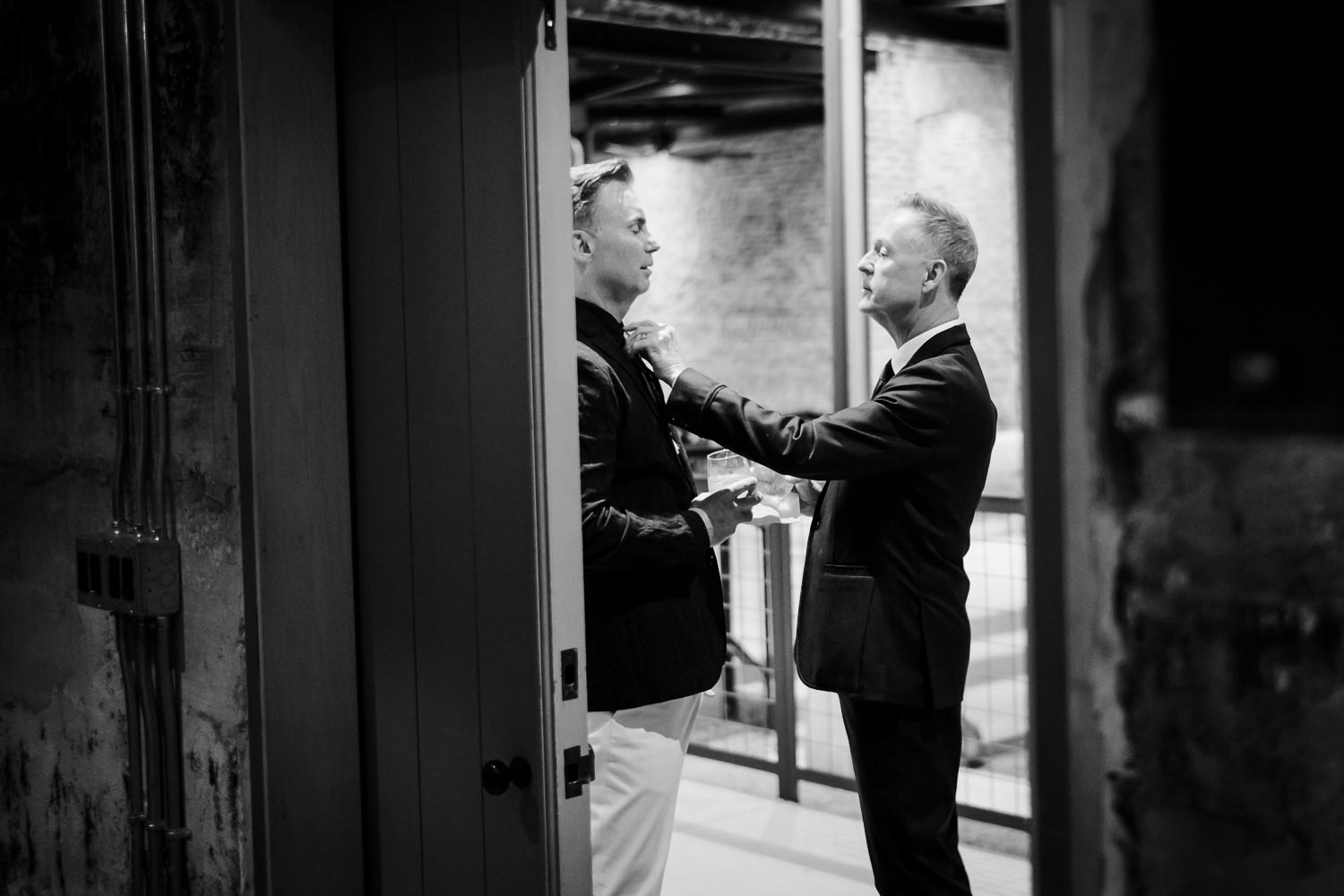 Lovely moment as groom fixes groom tie LM104600