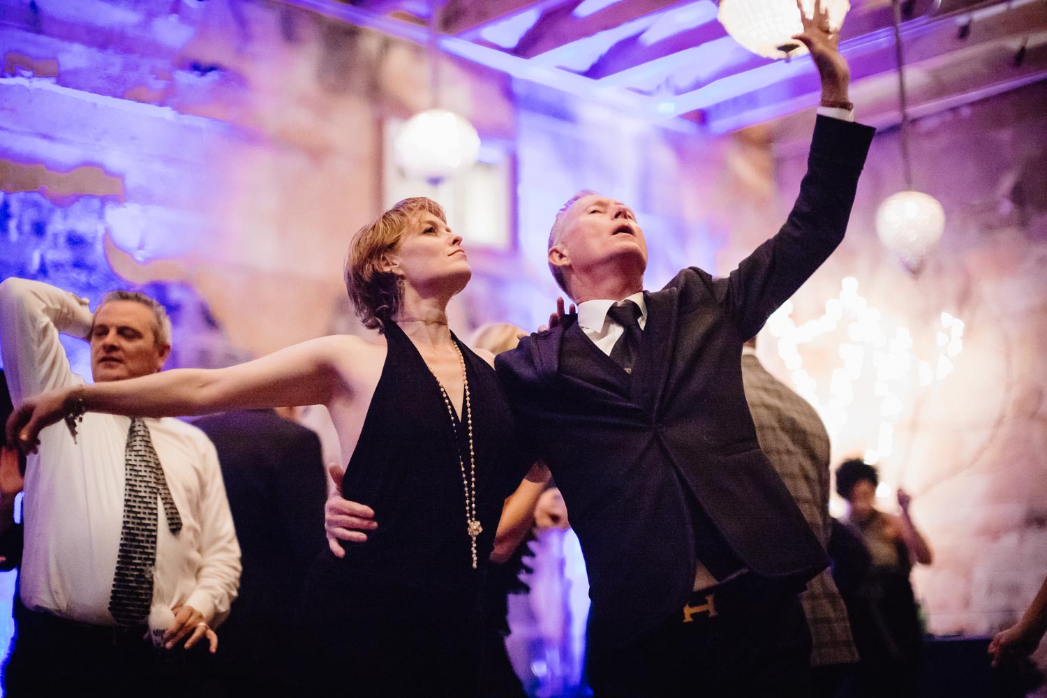 A guest and the groom dance at a wedding receptionLM104975
