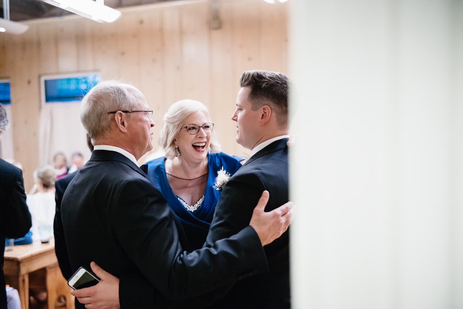 Dans mother and father share a laugh before wedding ceremony