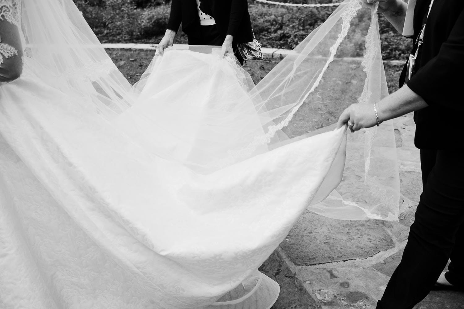 The brides dress is held by the wedding corordiantors before the ceremony