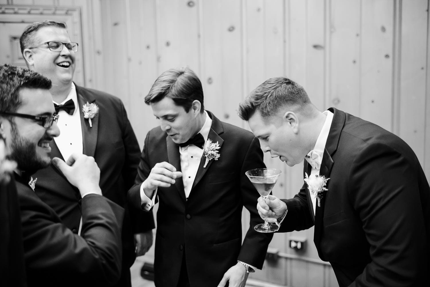 The groom and groomsmen enjoy their first drink together after tying the knot