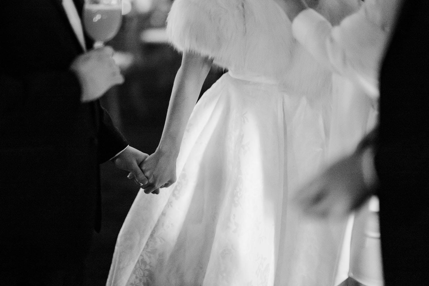 The couple hold hands during meet and greet during a fall wedding reception at The Witte Museum