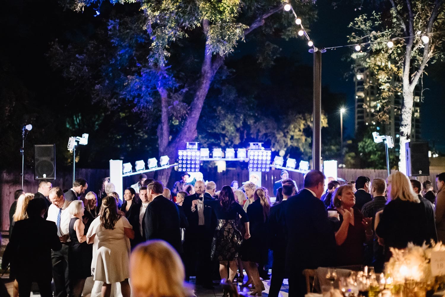 A wide shot of a outdoor fall wedding reception at The Witte Museum
