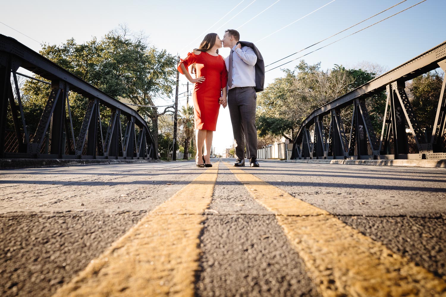 Beautiful engaged couple Arsenal Bridge over the San Antonio river kiss