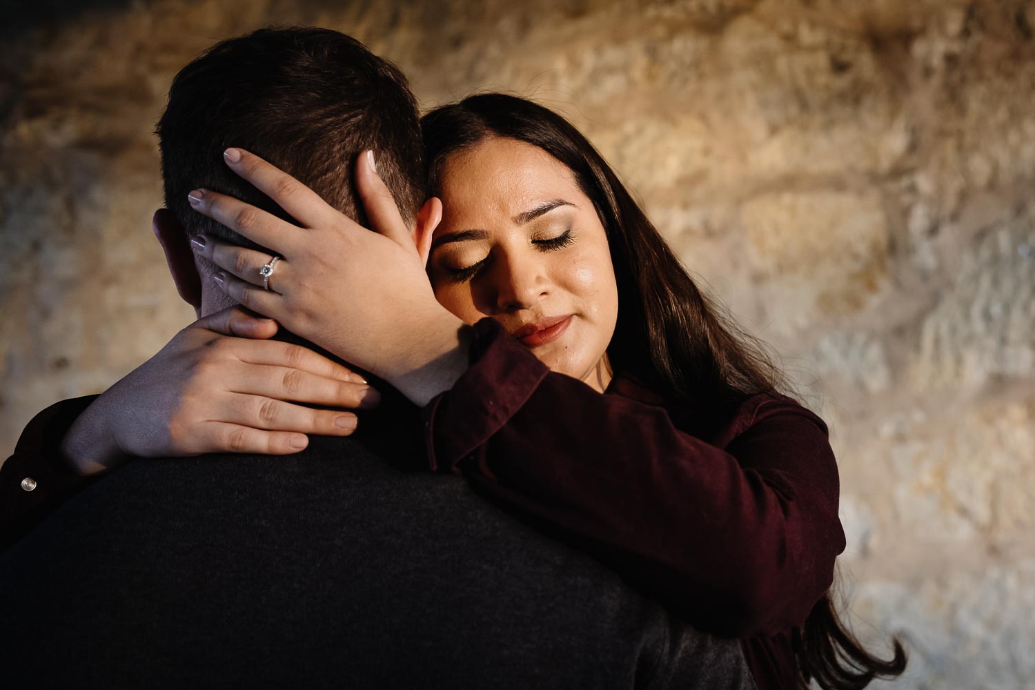 Couple with her hands cradling his head