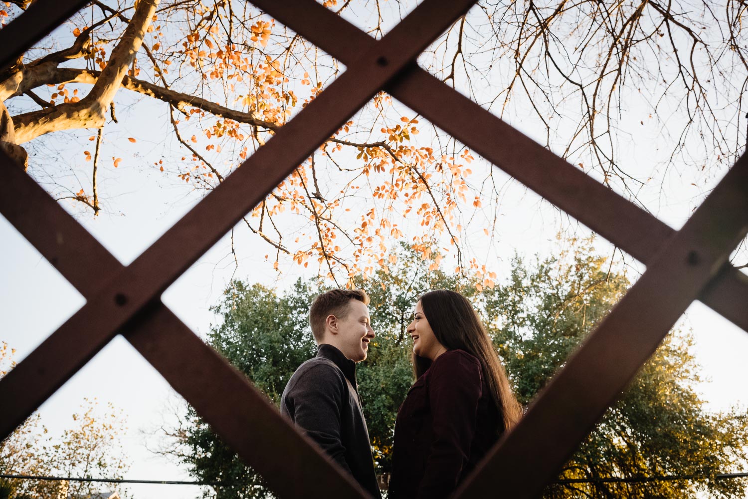 Couple photographed though fence San Antonio engagement session