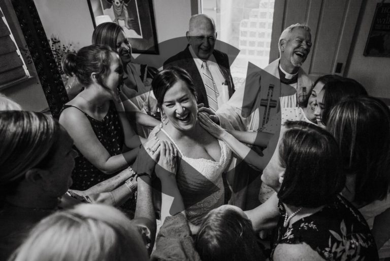 Joyous reaction as bride is surrounded by family and friends