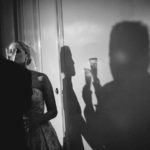 Shadow on wall shows clinking of glasses and the couples at The Houstonian during cake cutting - a WPJA award winning images