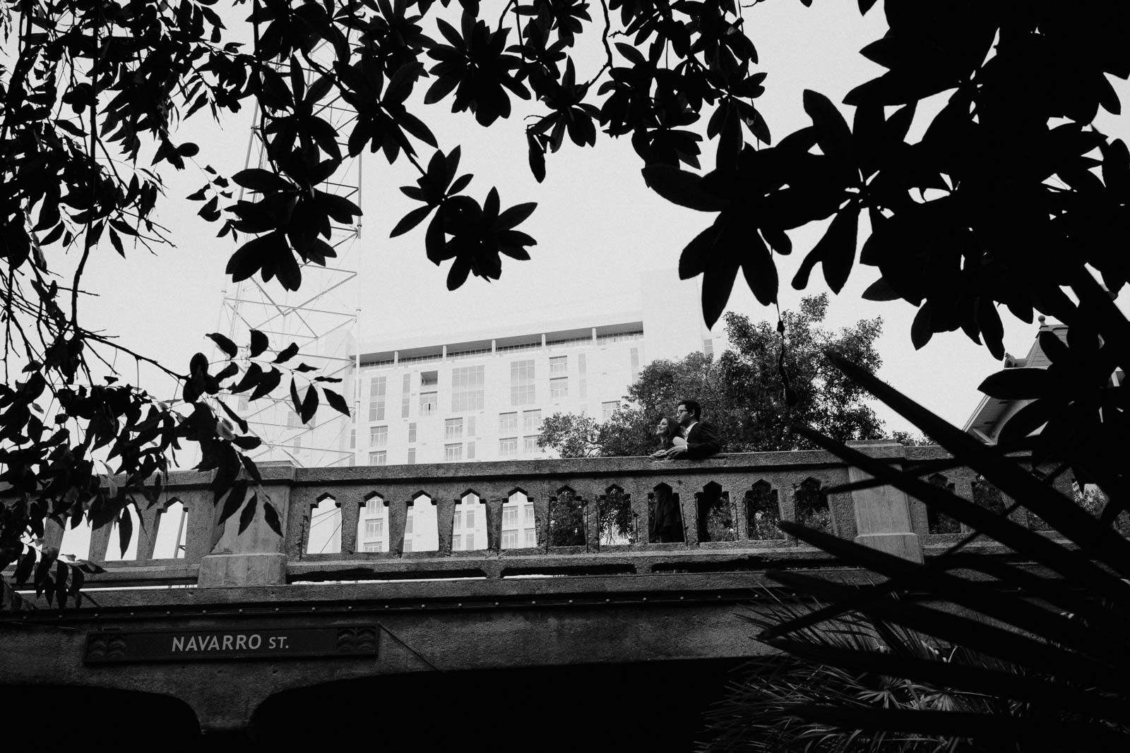 Couple pose for engagement pictures on Navarro Street overlooking the riverwalk - Leica Wedding Photographer-- 1San Antonio engagement shoot downtown - Philip Thomas