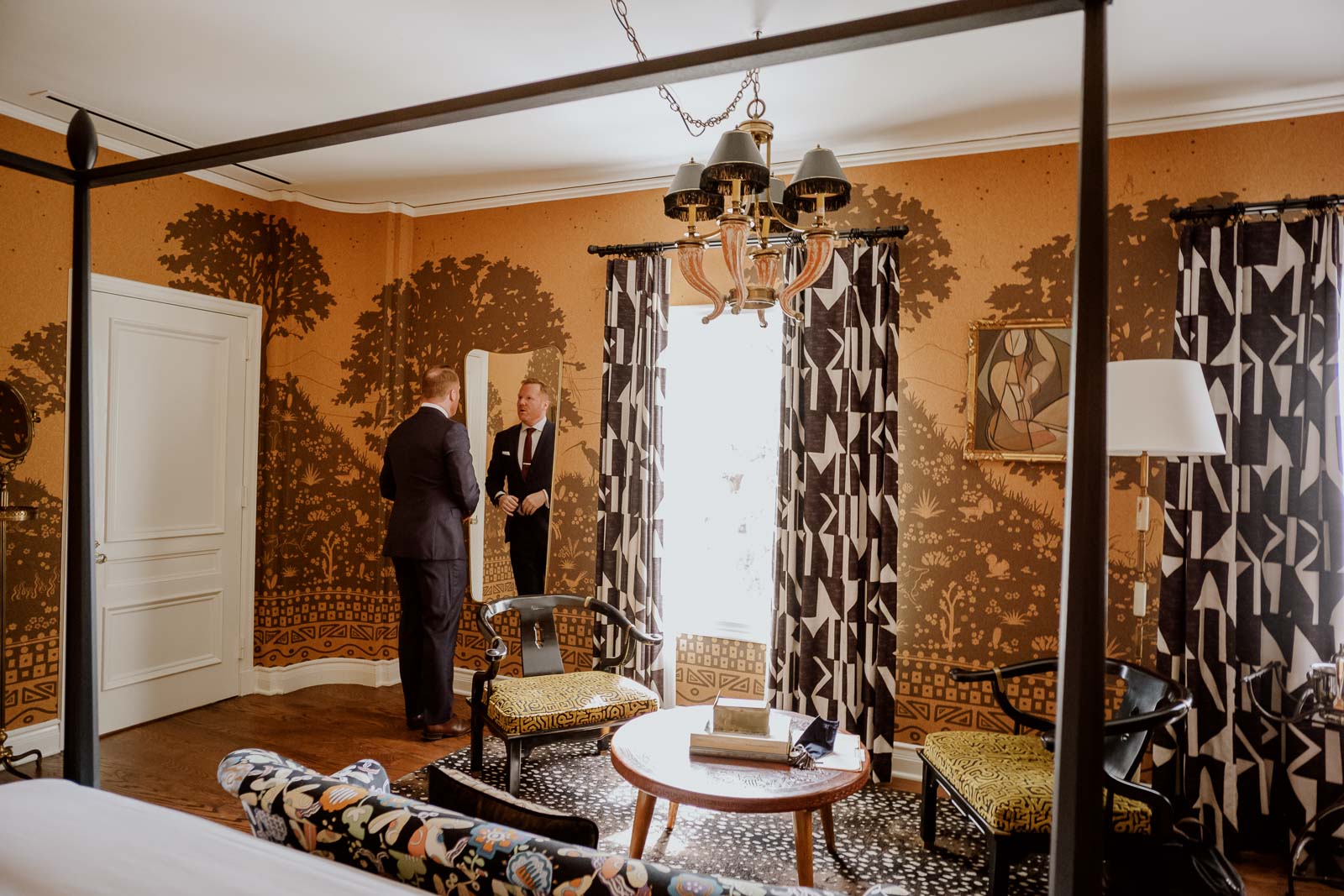 The groom checks himself in the mirror at Commodore Perry Estate Austin Texa