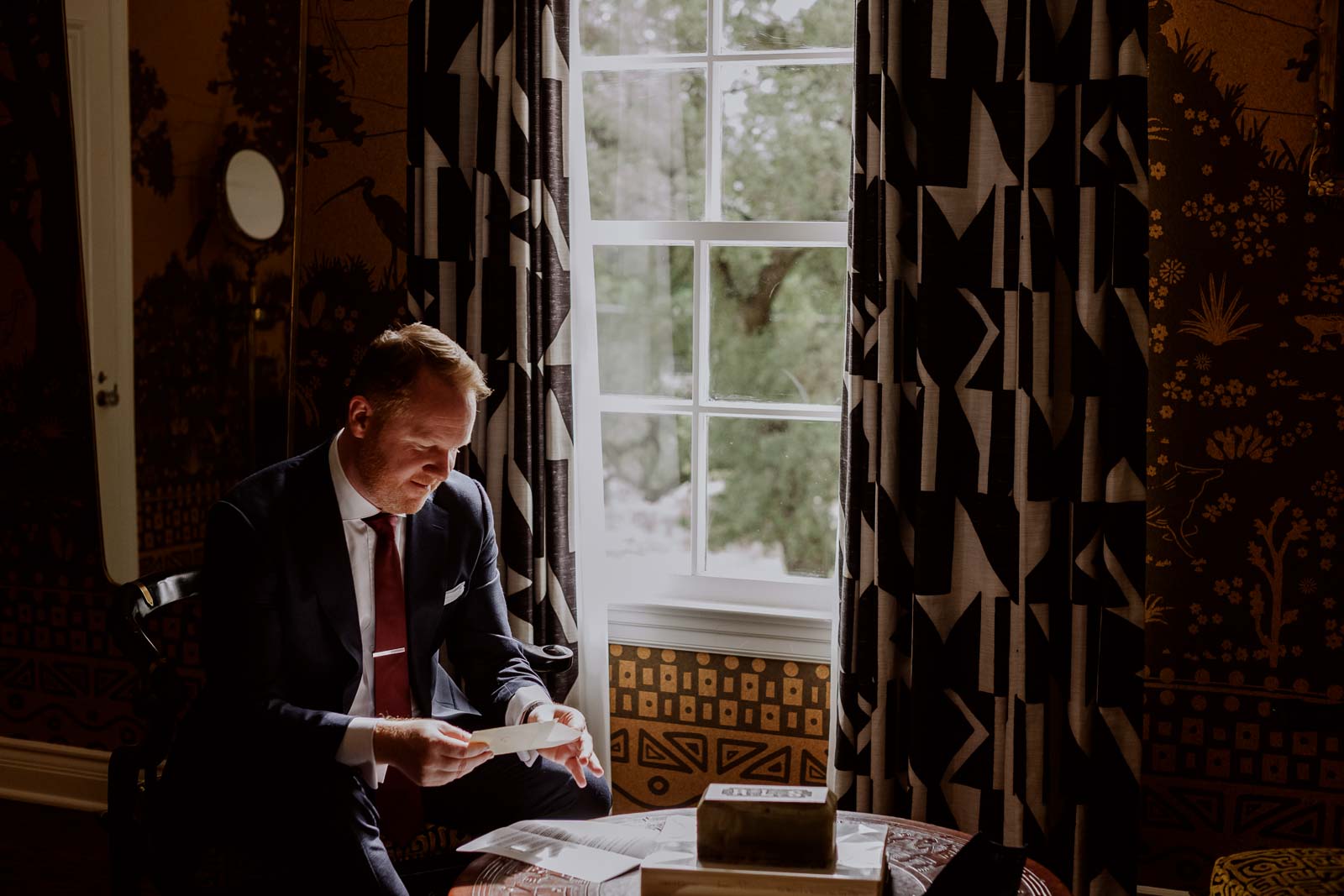 The groom opens a love letter from his bridde to be at Commodore Perry Estate Austin Texa