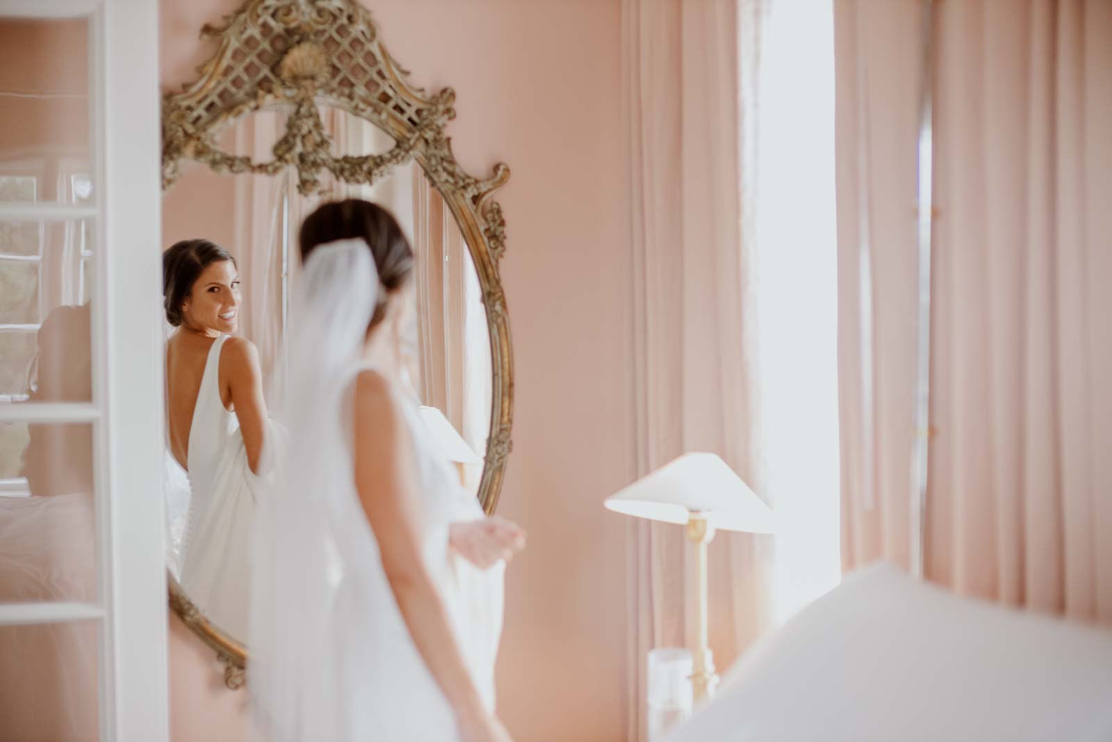 Bride sees herself in the mirror at Commodore Perry Estate Austin Texa
