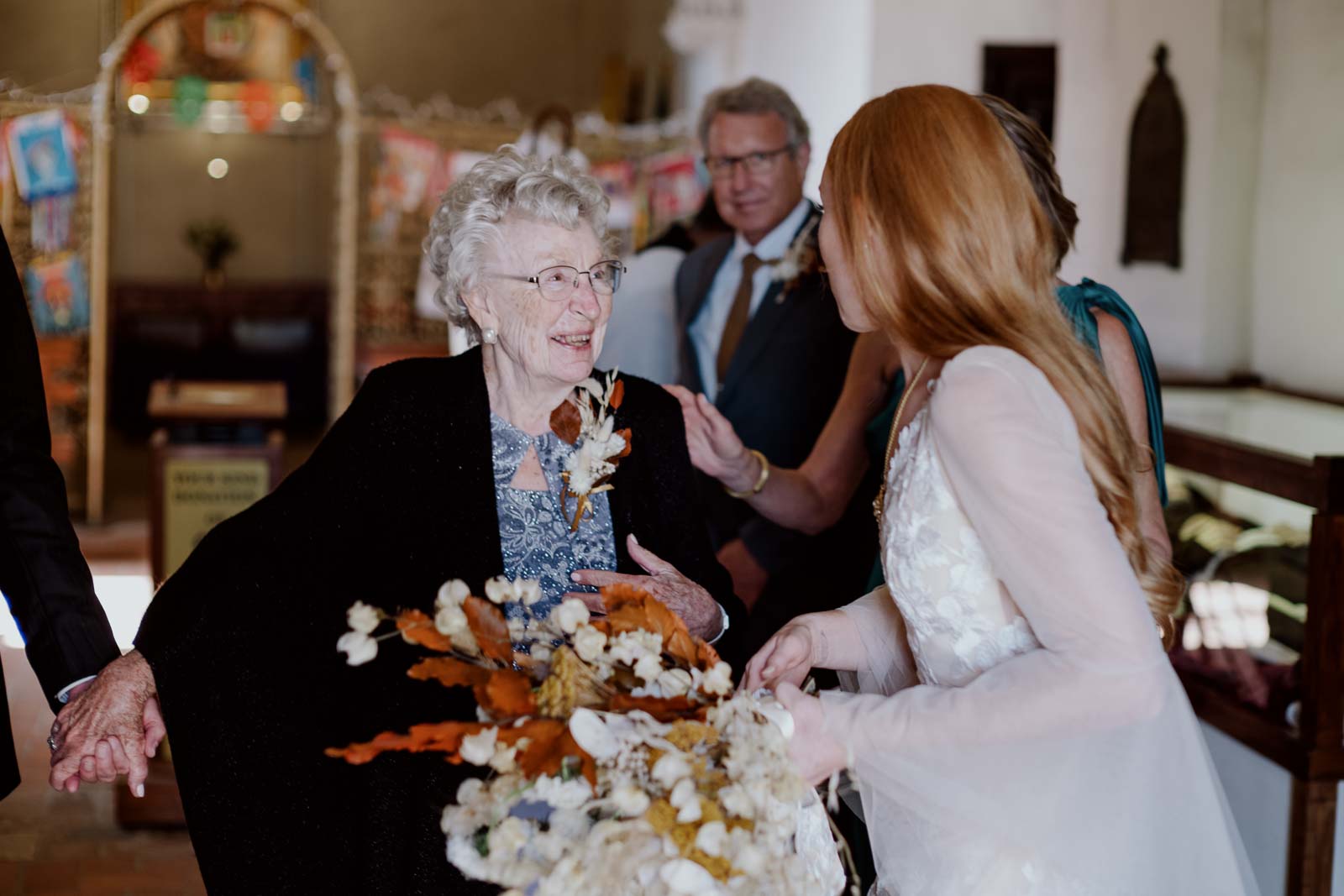 A sweet moment as the brides grandmother congrat the bride at the Missions San Jose Church