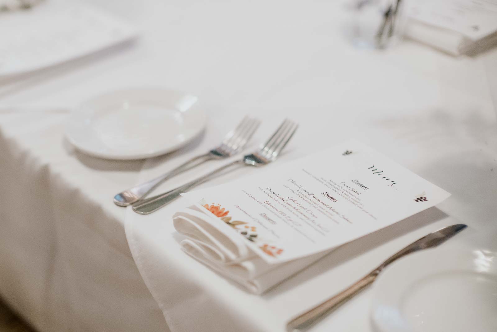 Dinner menus lay on the table at Ouisie's Table in Houston wedding reception