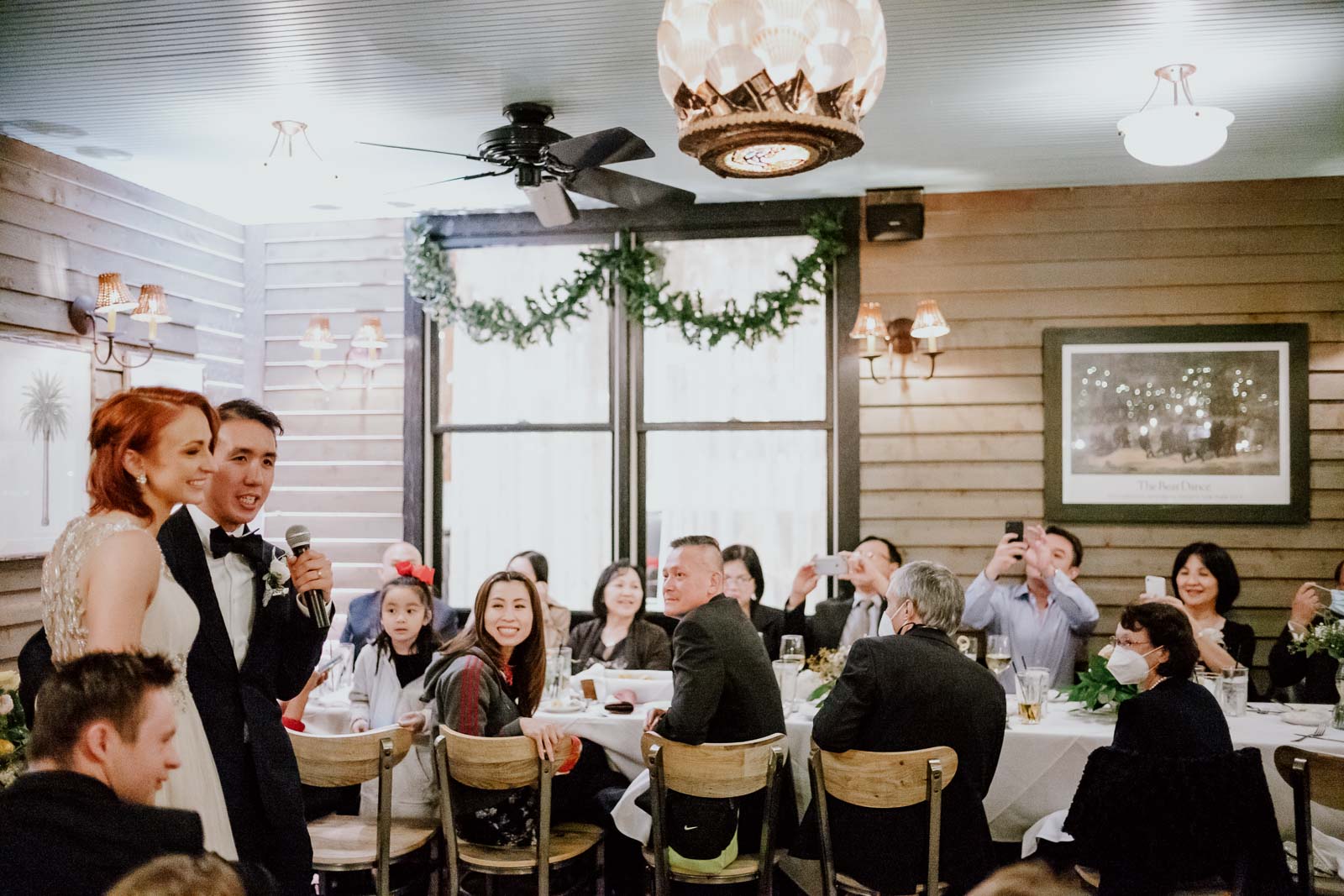 Speeches by the groom and bride with Vietnamese family and friends seated at Ouisie's Table in Houston wedding reception