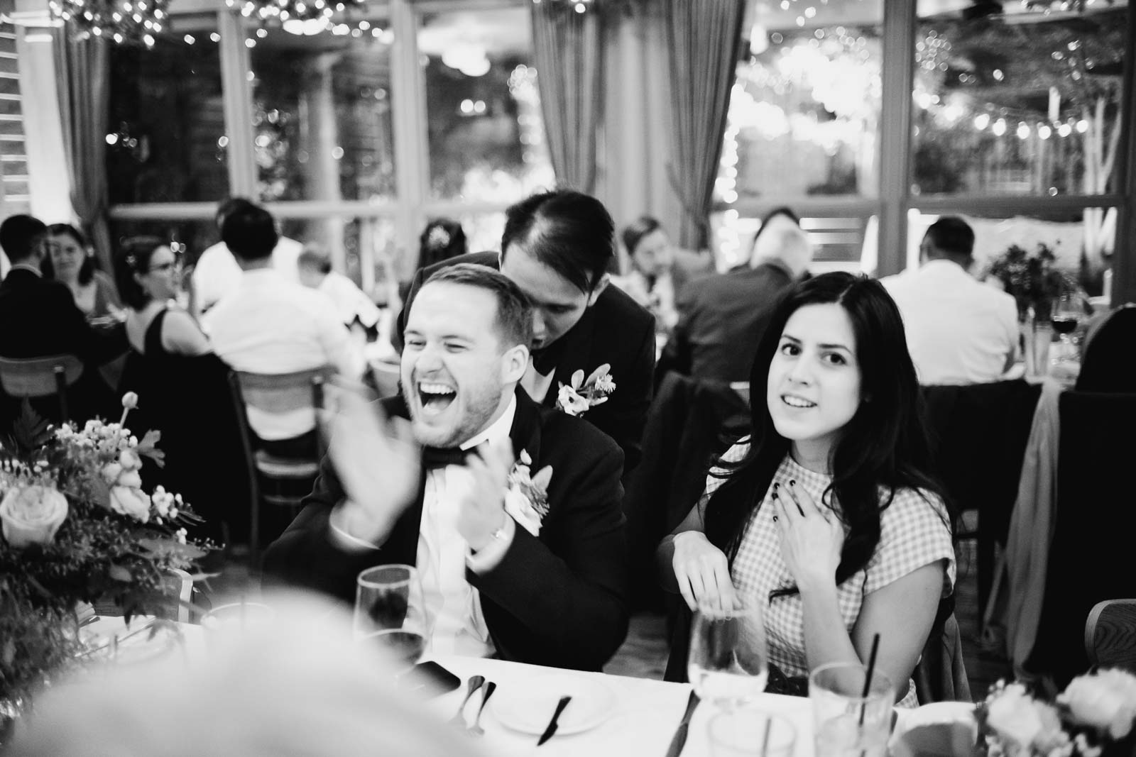 Best man and groom share a joke at Ouisie's Table in Houston