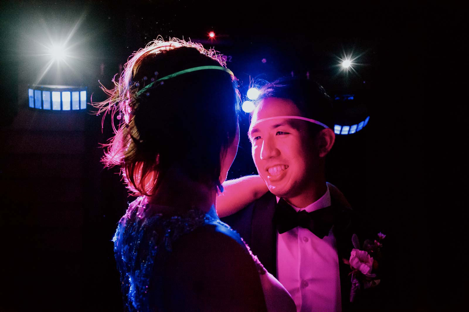 The groom looks adoringly on his bride at Ouisie's Table in Houston