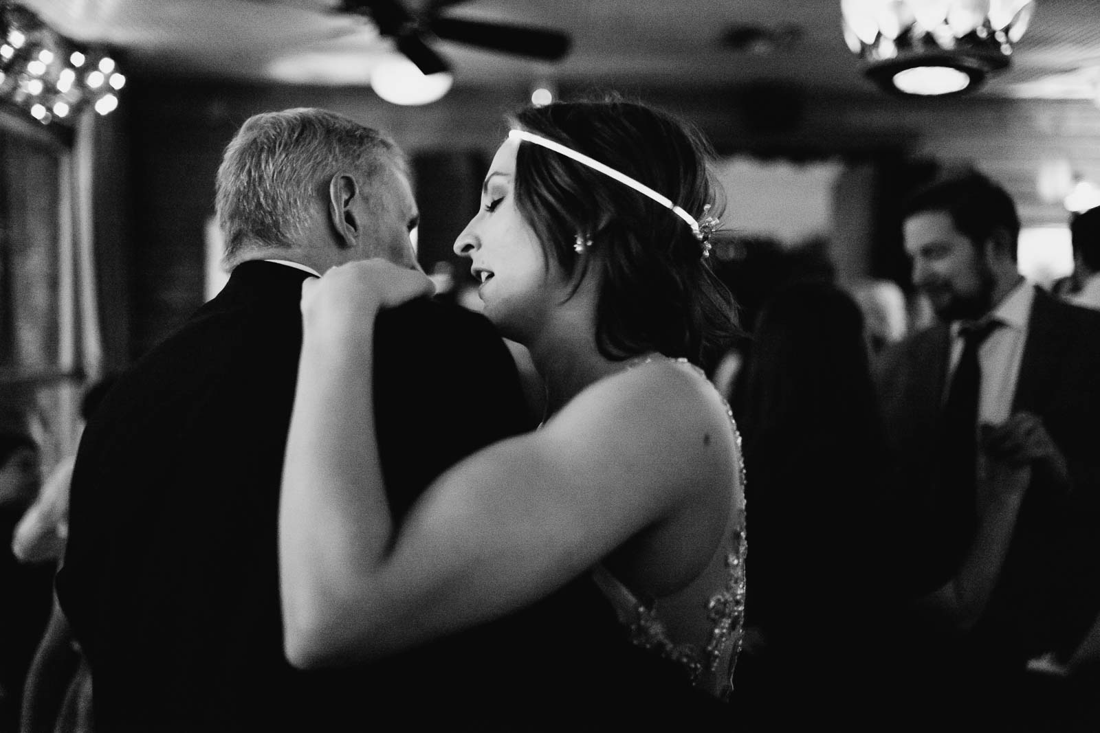 Father and bride dance together in a close embrace at Martin and Katie at Ouisie's Table in Houston.
