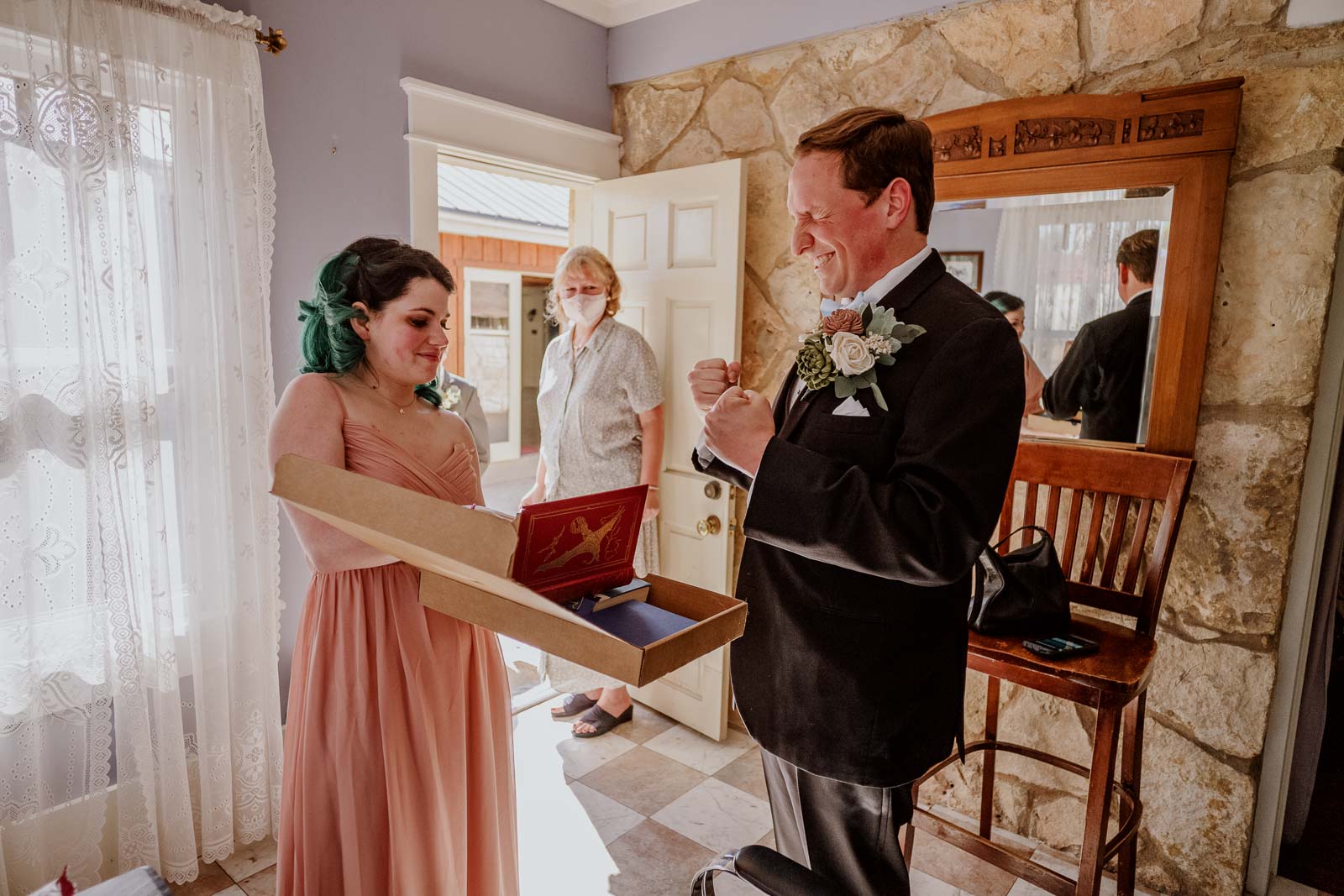 Pre-wedding gifts and the look on the groom’s face is priceless as he receives some awesome books from his bride